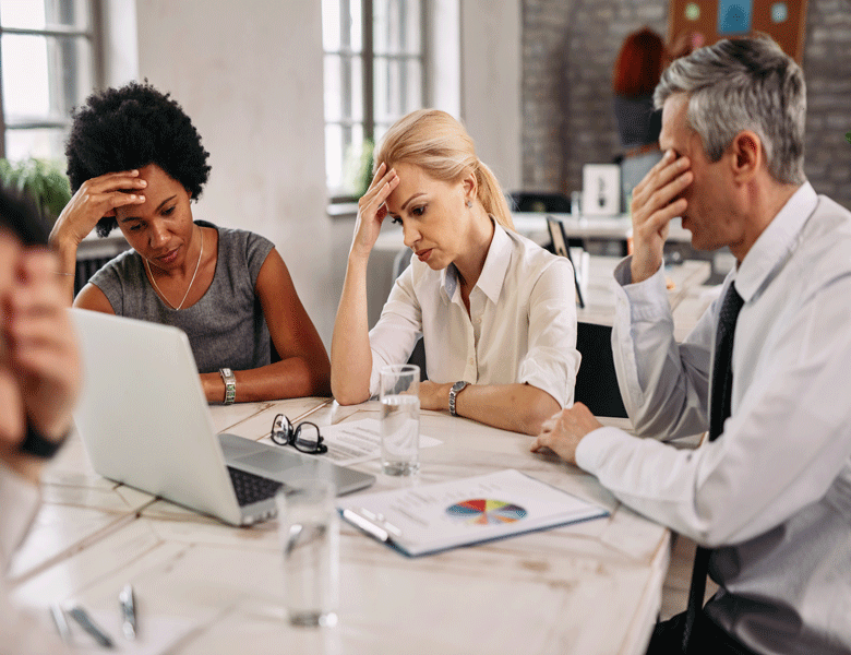 group-business-colleagues-having-headache-while-working-laptop-trying-solve-problems-meeting